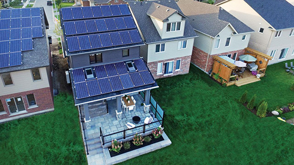 Residential area backyards, and the roofs of many homes with solar panels.
