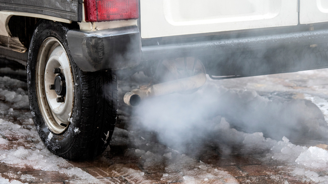 Car exhaust pipe releasing smoke.