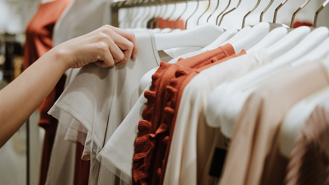 Clothing store, where someone is checking out a shirt.