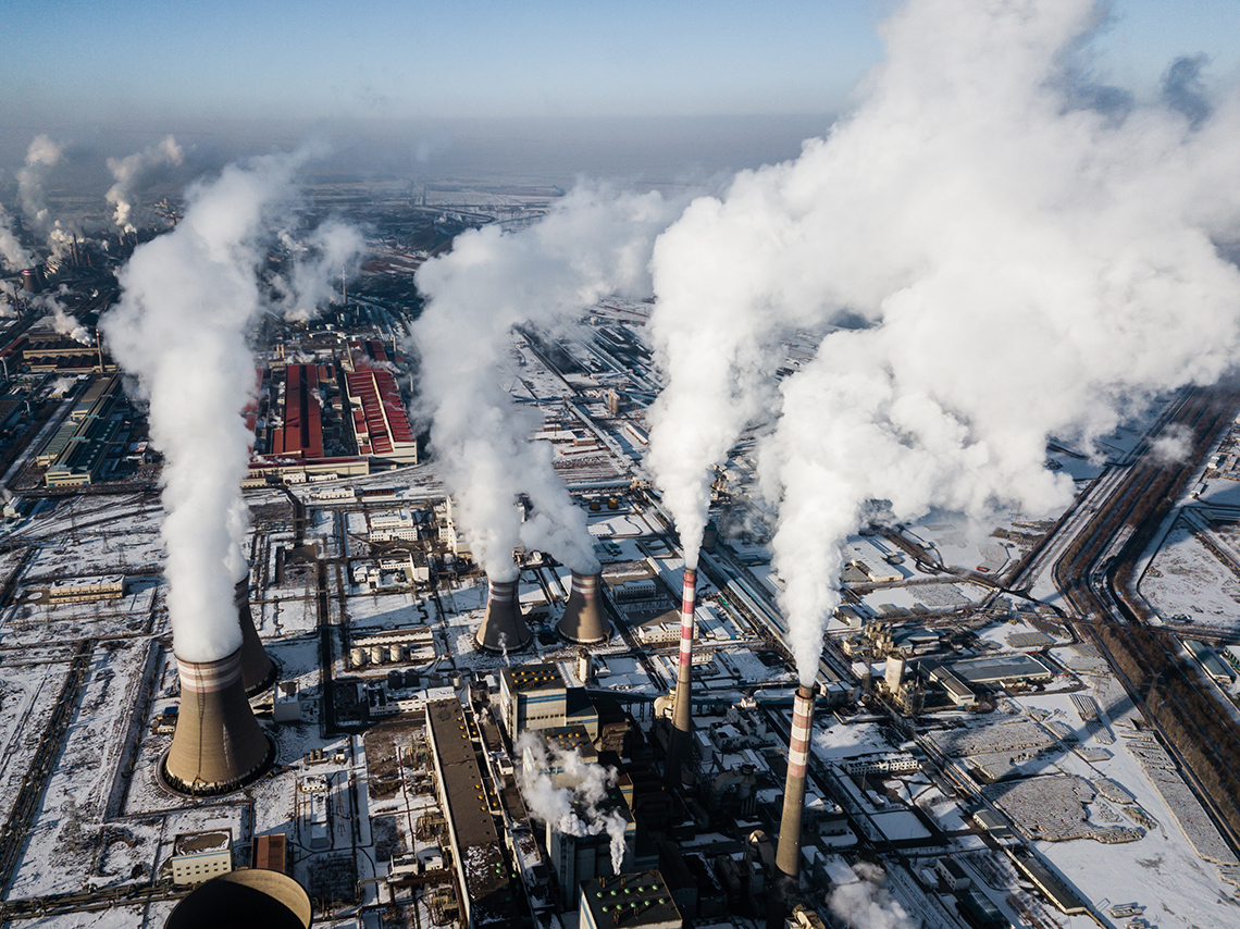 The chimneys of a factor working and producing a lot of steam.
