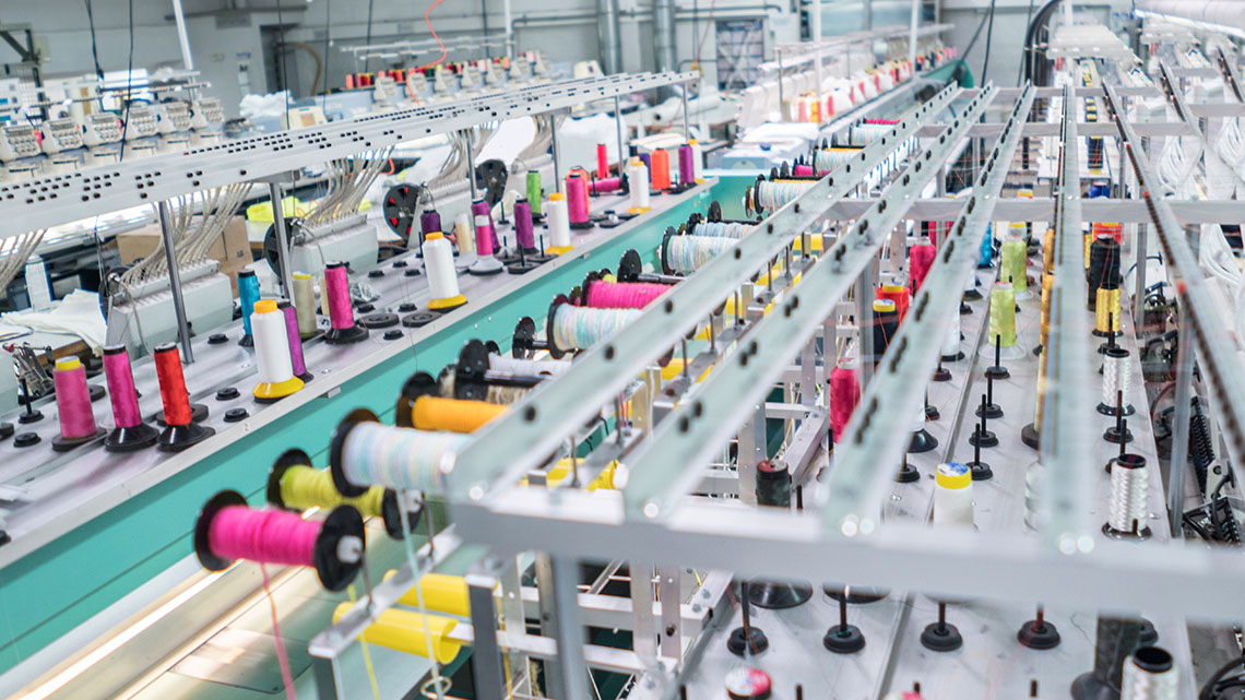 A clothing factory with machines for sewing.