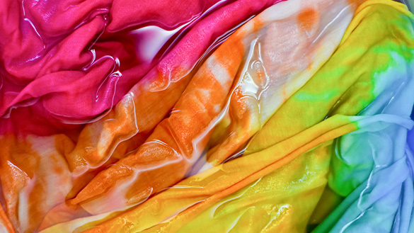Colourful tie dye fabric in water.