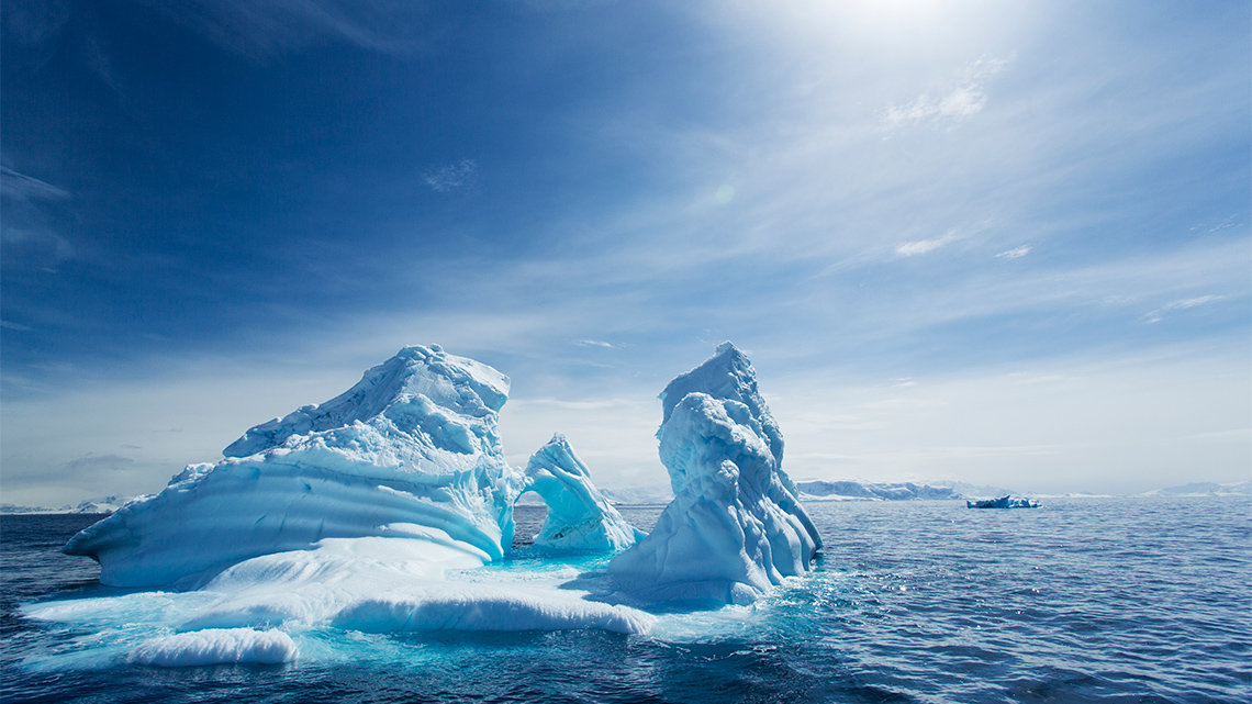 Iceberg in Antarctica, surrounded by cold waters.