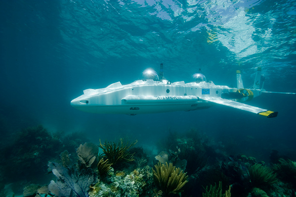 A submarine covered with lights moving through the water.