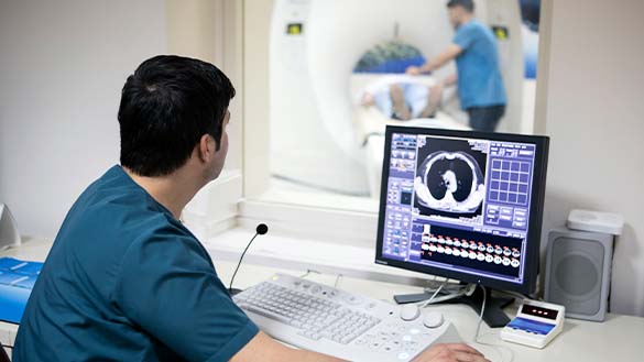 A doctor examining the images that are created from a PET scan.