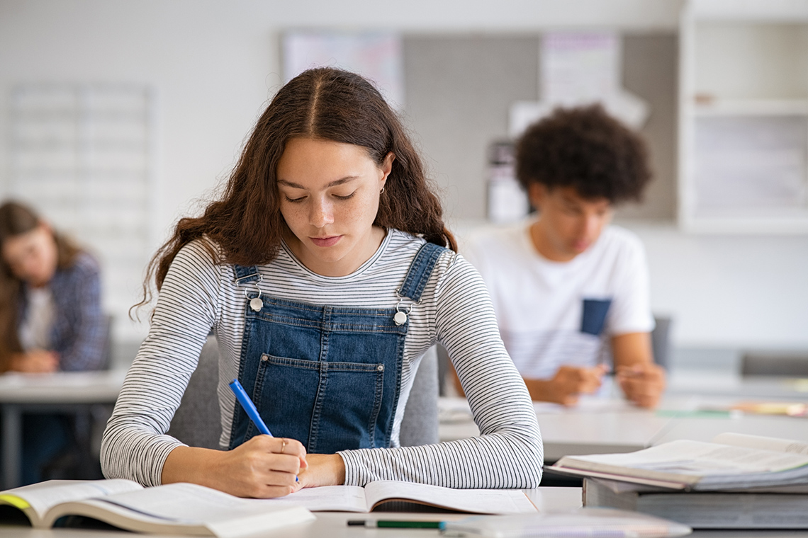 Students writing notes in class.
