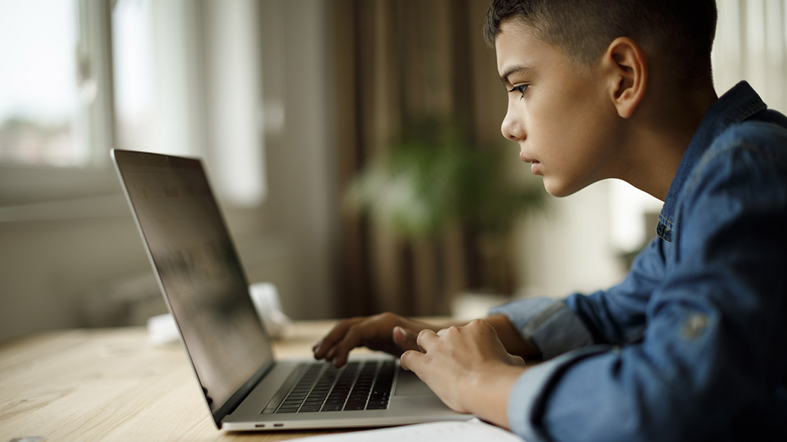 A student looking at their computer.