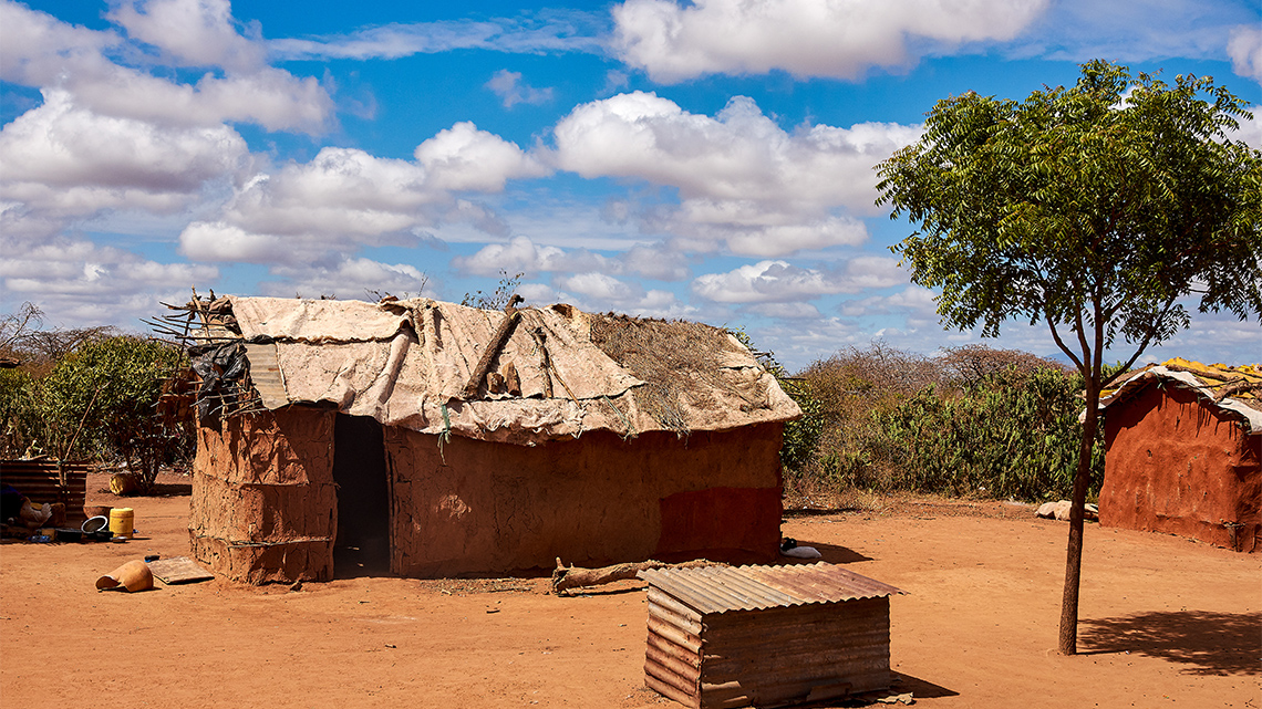 A hut made from mud with a simple wood frame.