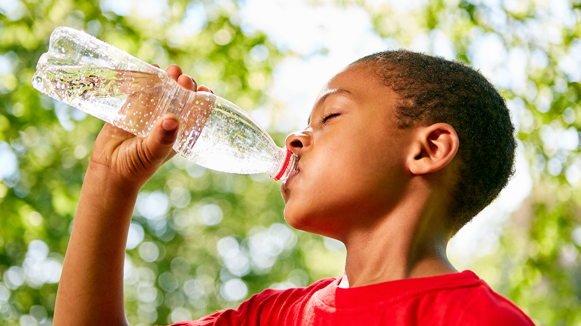 A learner drinking water from a bottle.