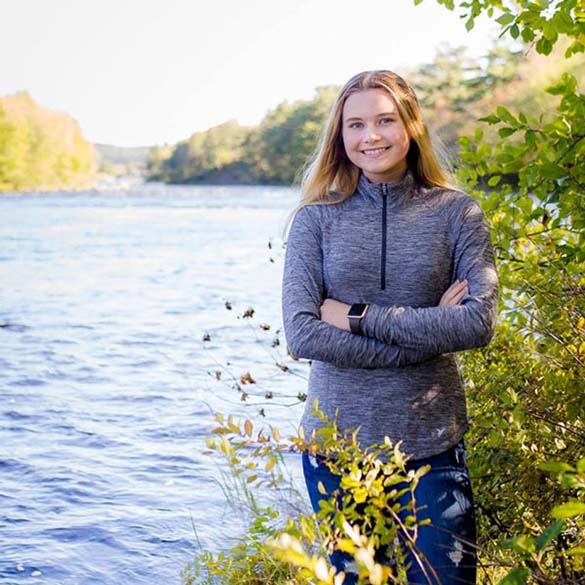 Stella Bowes standing beside the river.