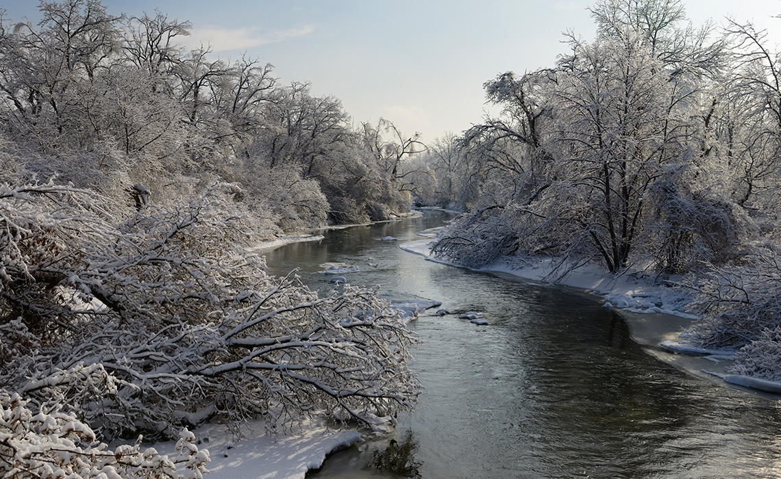 Water flows in a river even in the winter.