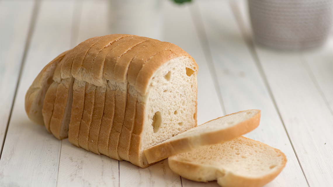 A sliced loaf of bread on a counter.