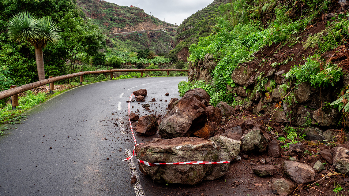 Rock slides on the side of a road after an earthquake.