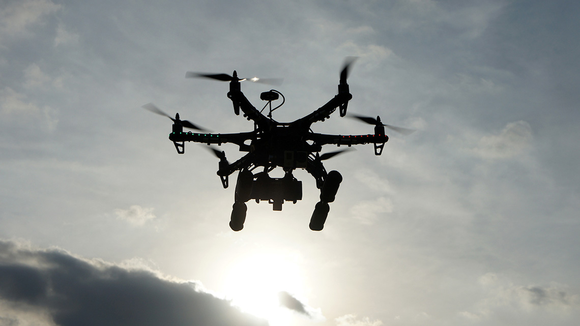 A remote-controlled drone flying in the sky.