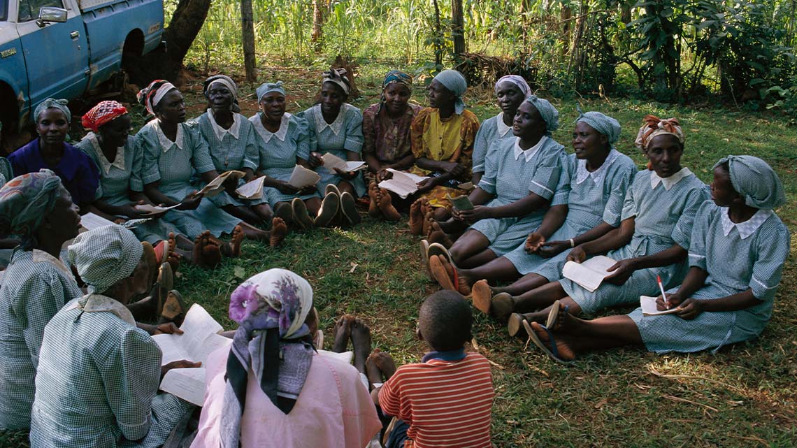 Kenyan women gathering in a circle to discuss activism and the environment.