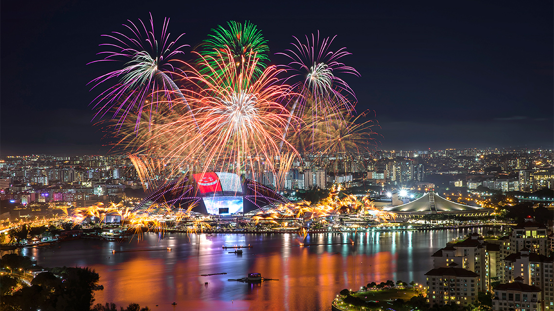 Fireworks lit over a stadium at night.