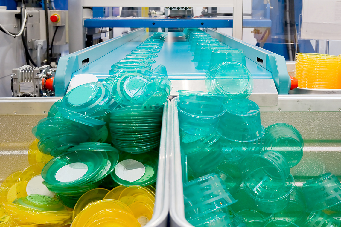 A production line filled with plastic containers.