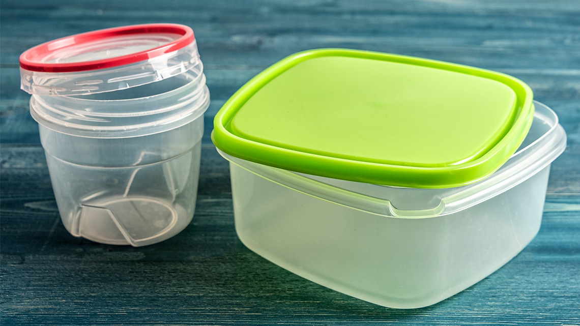 Plastic food containers on a wooden table