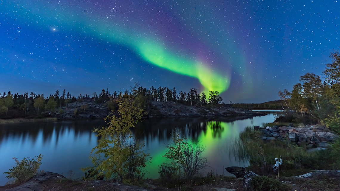 The northern lights shining across the night sky.