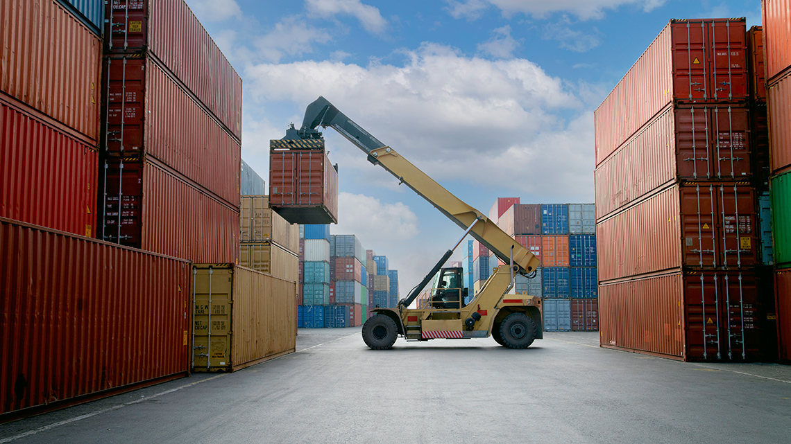 A crane lifting a container at a commercial port.