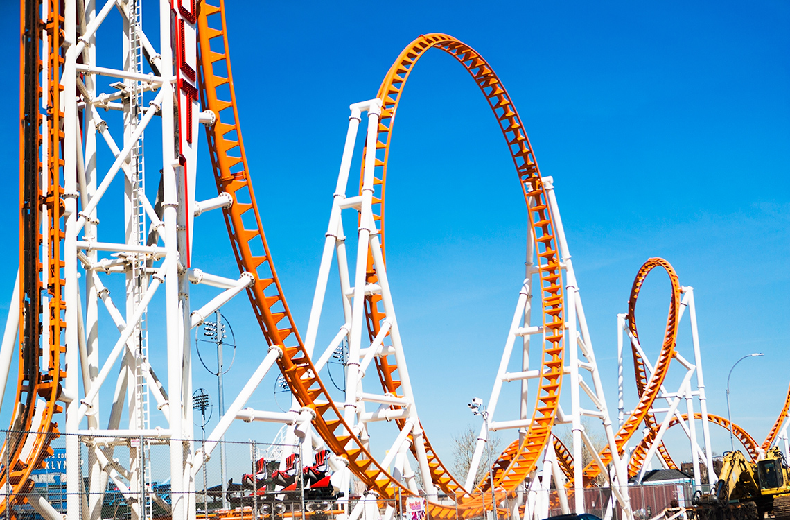 A roller coaster which travels up and down and loops around many times.