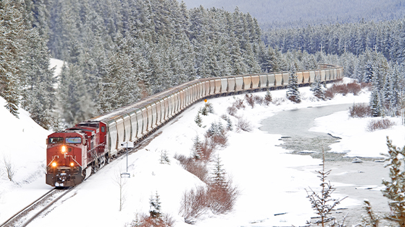 A train entering a stop to pick up passengers.