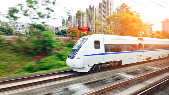 A train entering a stop to pick up passengers.