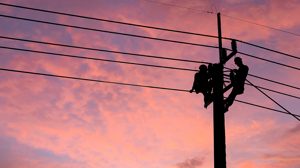 Two-line workers making repairs.
