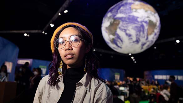 Mitzi Jonelle Tan featured with the image of the earth behind her.
