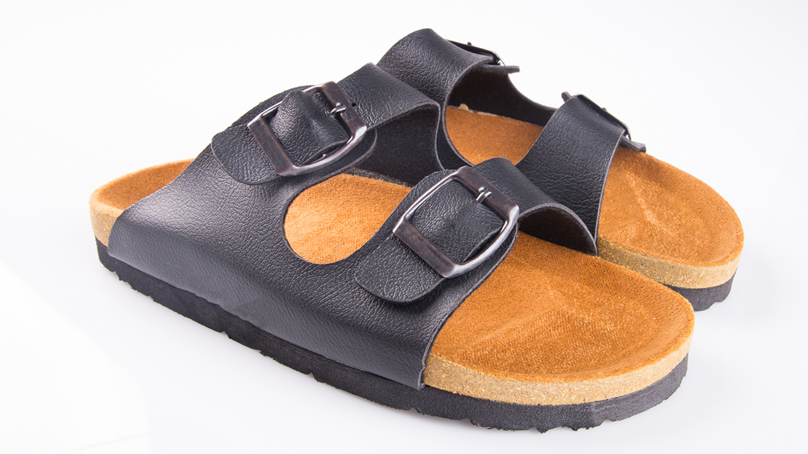 A pair of two strap sandals with buckles.