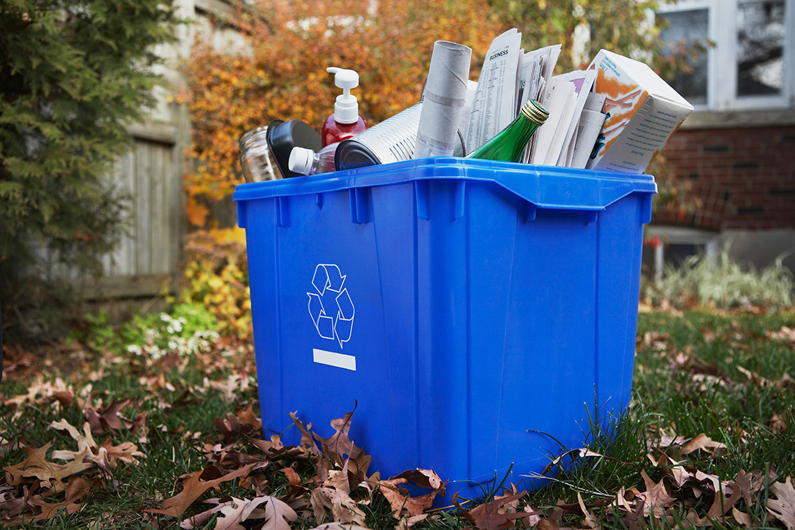 A recycling bin filled with recyclable materials.