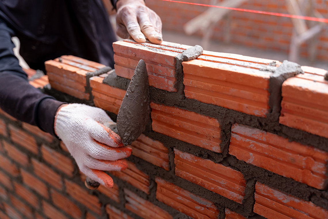 A mason laying bricks.