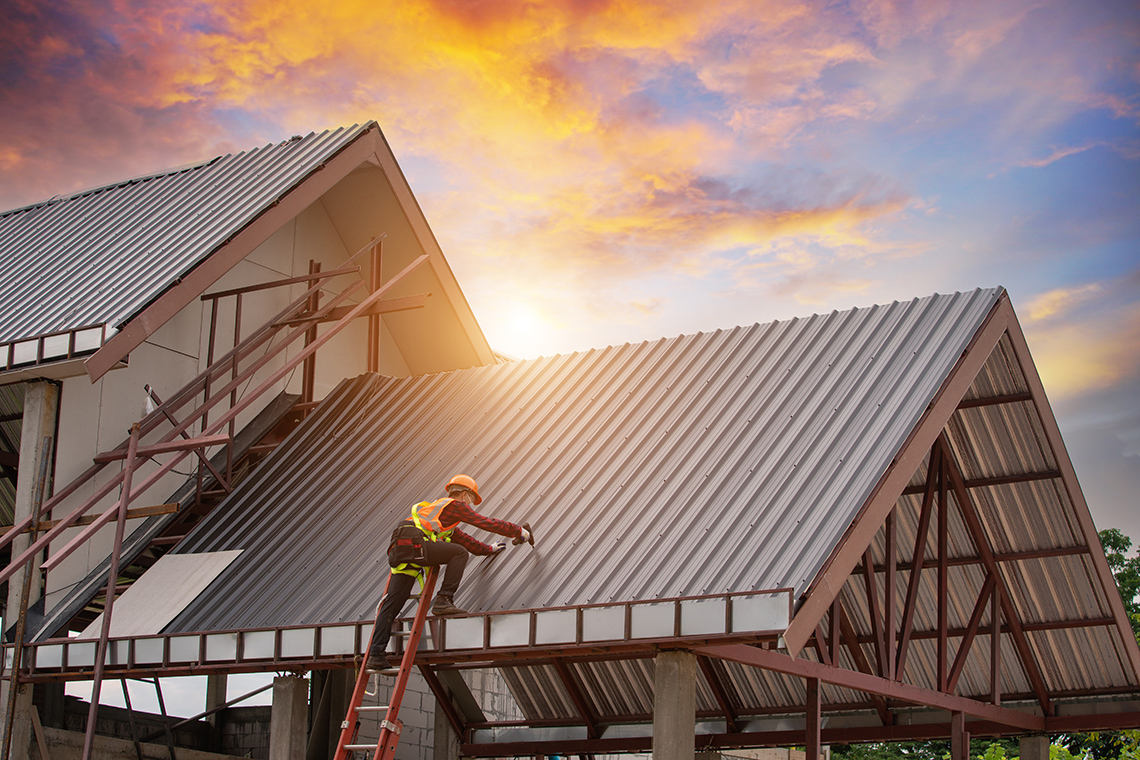 A roofer installing a roof in a structure.