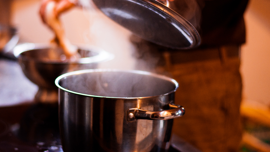 A pot steaming on a stove.