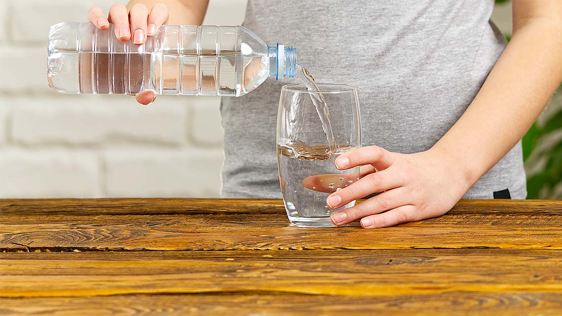 Clean water being poured into a drinking glass.