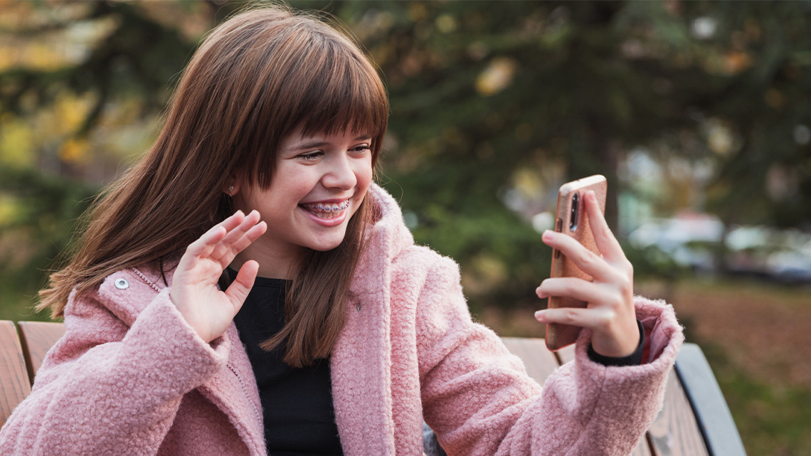 A person holding a camera facing them and talking to the camera.