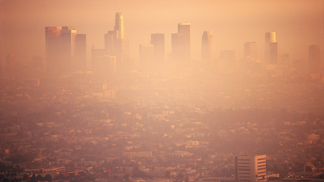 A dense city with many buildings. It is covered in a thick layer of smog.