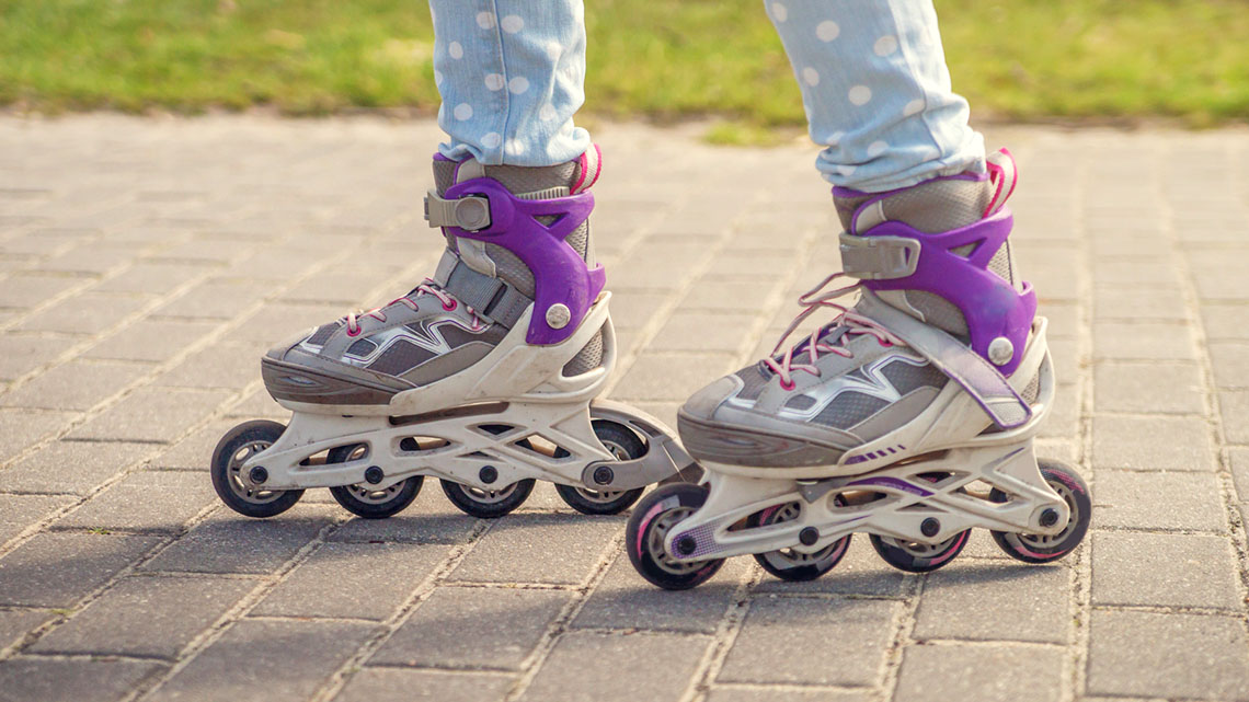 A child's feet in rollerblades. 