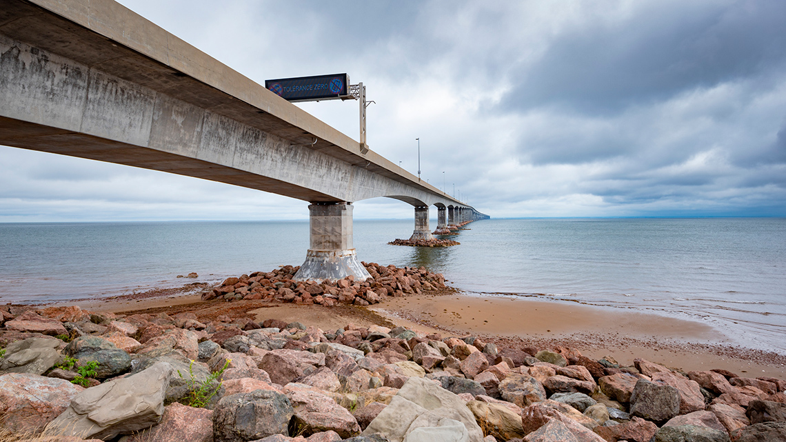 A road on a bridge crossing a large body of water.