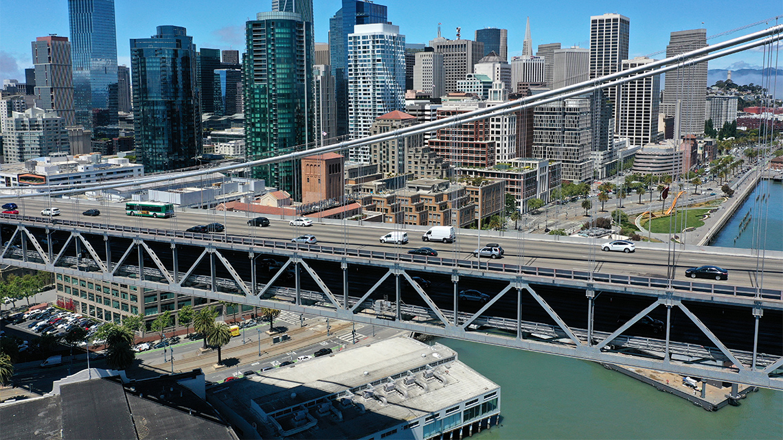 A bridge with two levels. The top level is supported over the bottom level with triangular beams.