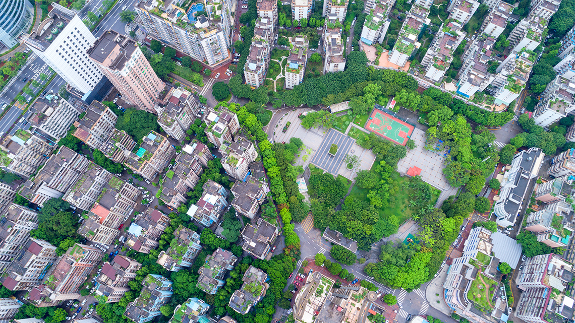 An aerial image of high-rise buildings with green areas around them