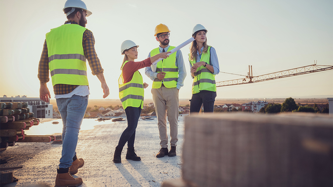 A team of people planning a rooftop design while on top of a building.
