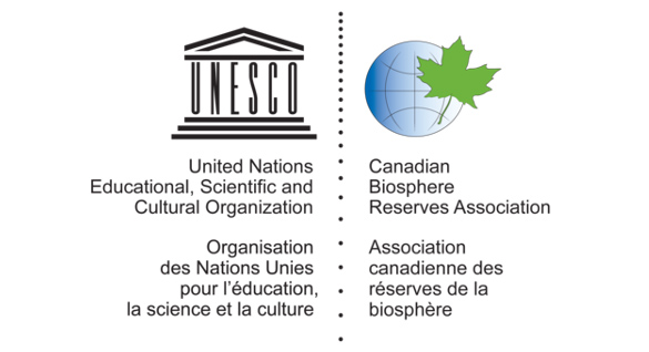 The logo from the Canadian Biosphere Reserves Association, which is a circle that represents planet Earth with a maple leaf on top.