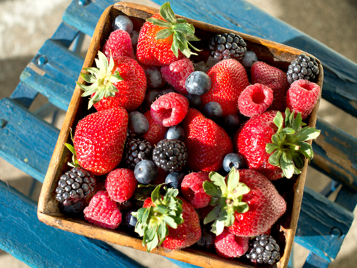 A basket of blueberries, strawberries, and raspberries