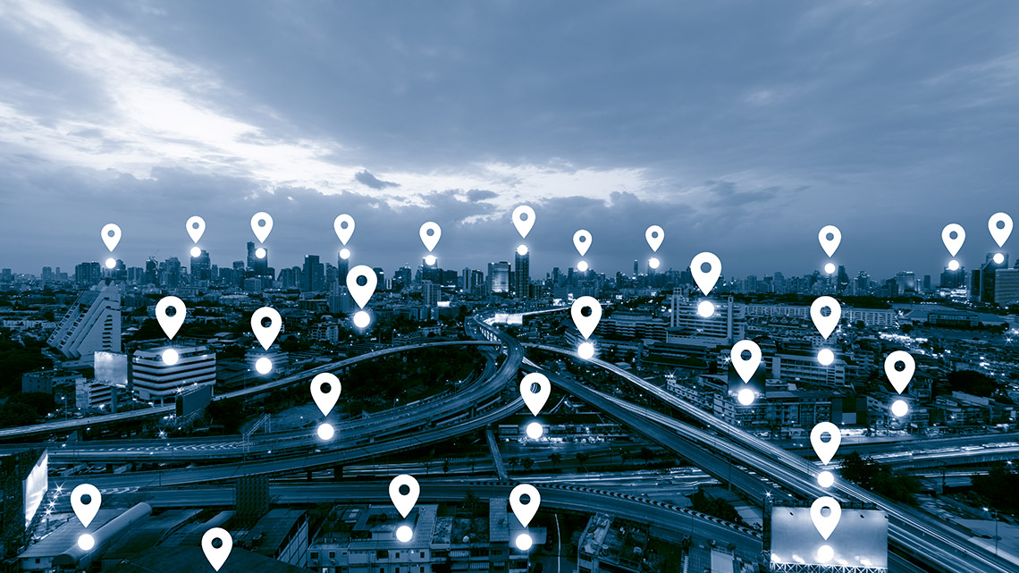 A cityscape during night time with multiple location points in various areas.