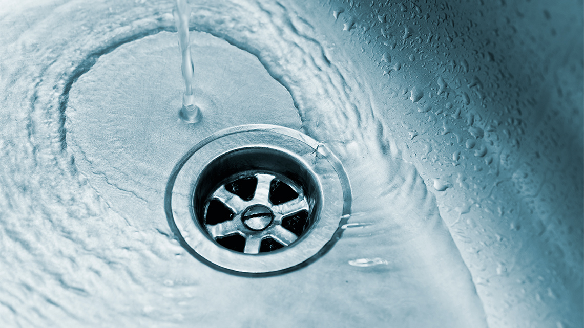 Water draining down a sink drain.