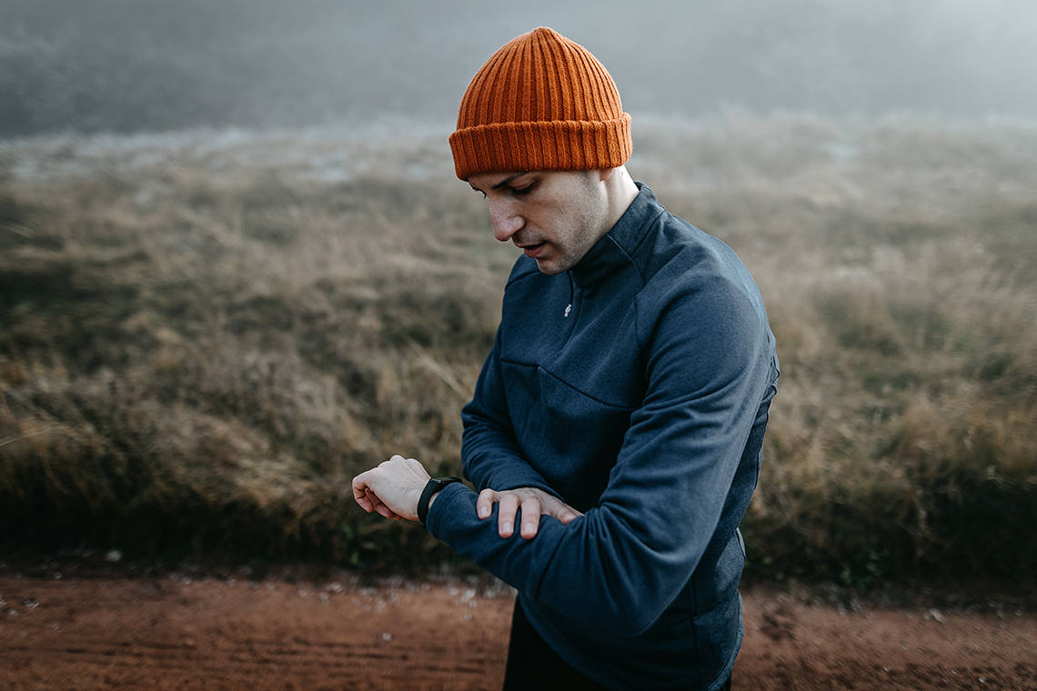 A person checking the wearable technology on their wrist.
