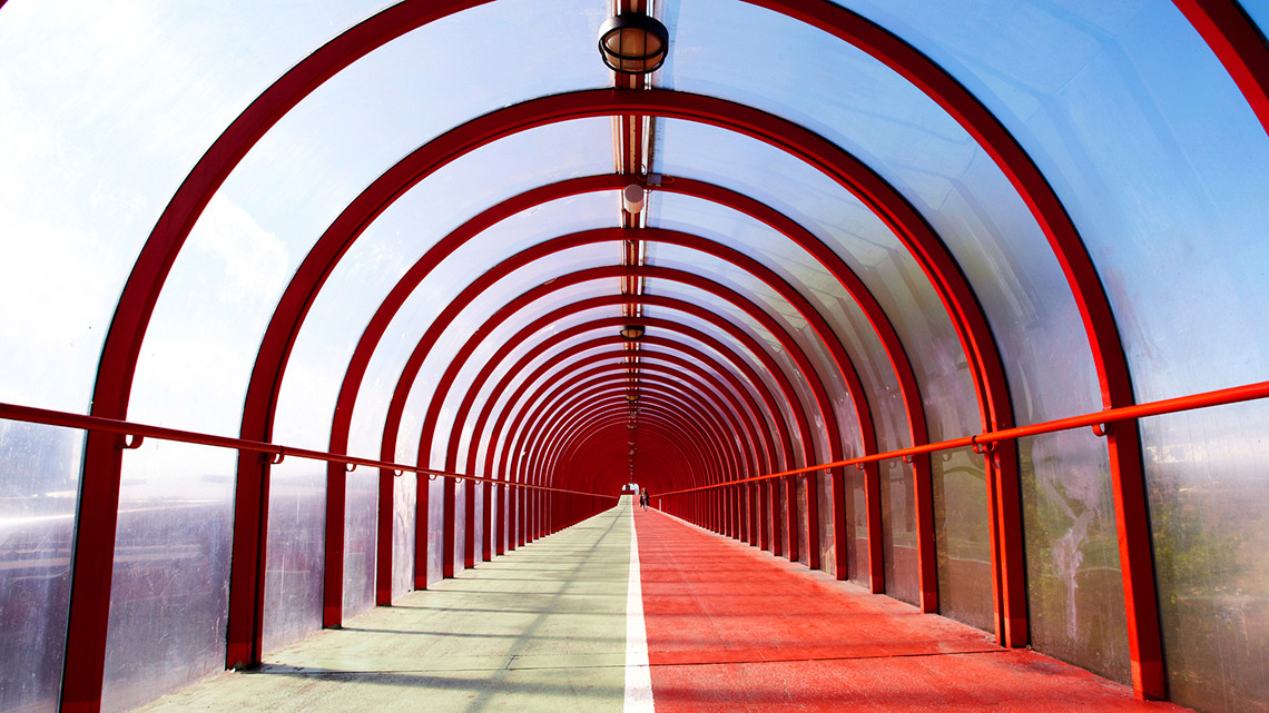Footbridge with arches and coloured walkway.
