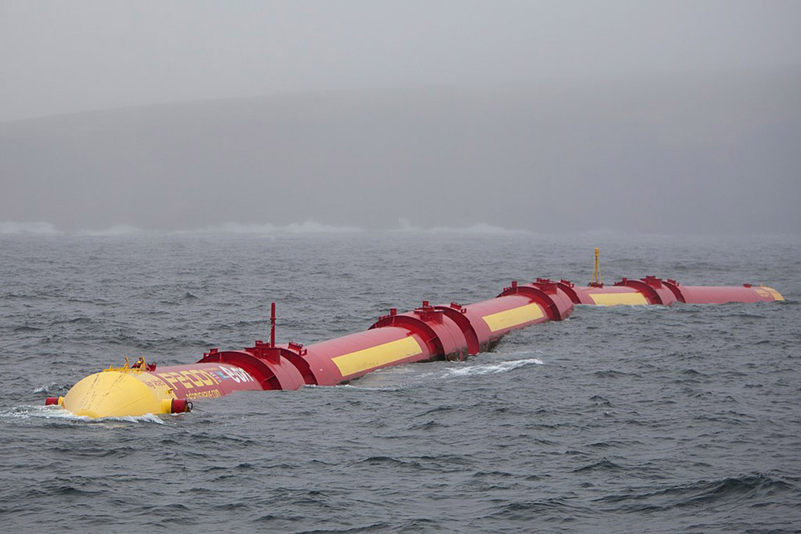 Large metal cylinders containing hydraulic motors linked with hinged joints floating in open water.
