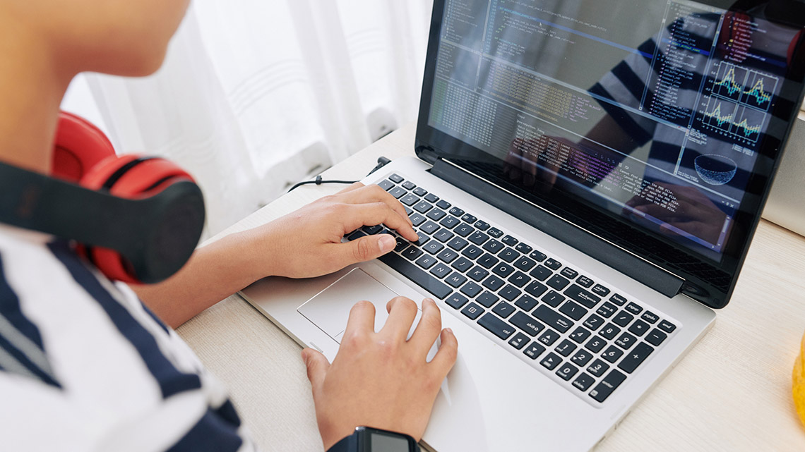 A person coding on their computer.